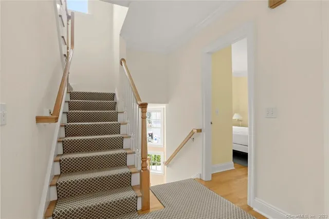 a view of entryway and hall with wooden floor