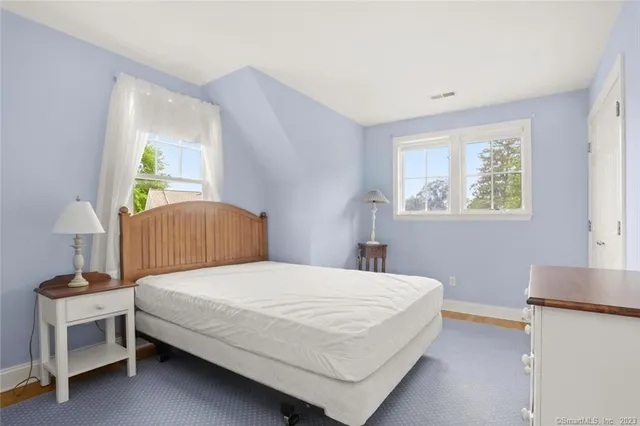 a bedroom with a bed and a table