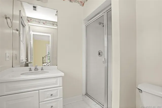 a bathroom with a sink vanity and a mirror