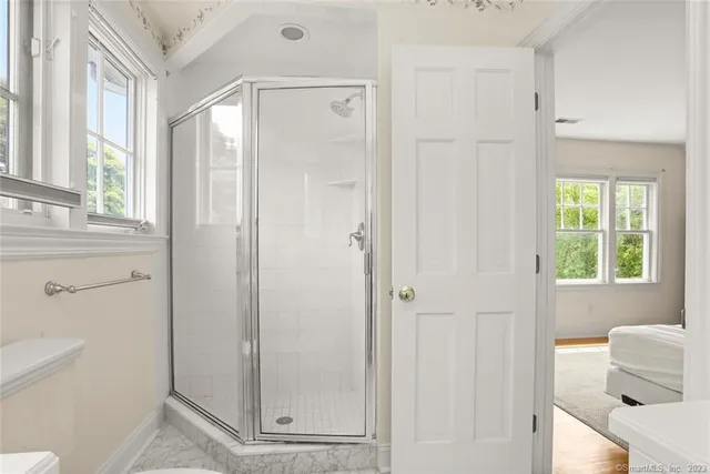a bathroom with a shower and toilet