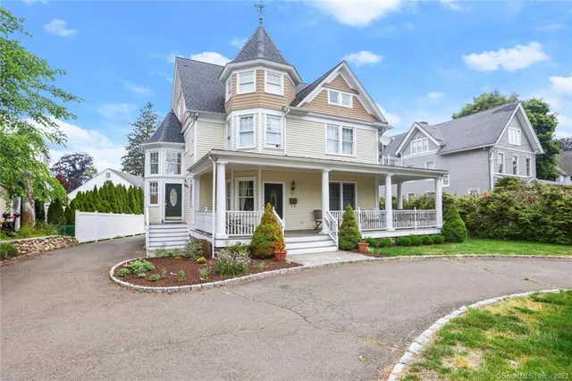 a front view of a house with garden and porch