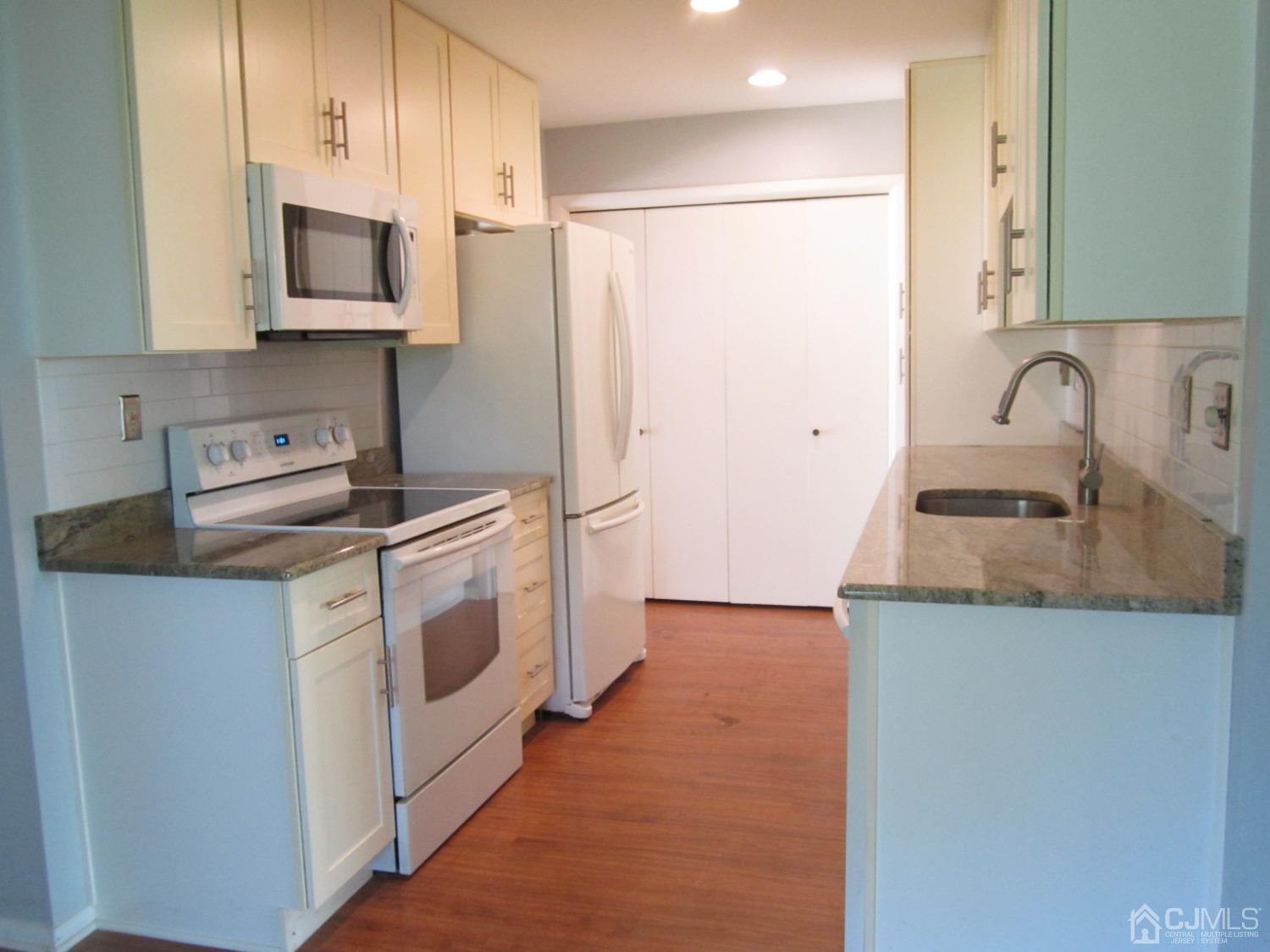 B Glen Road Monroe Township, NJ 08831 - Photo 8 of 28 a kitchen with stainless steel appliances white cabinets and a sink