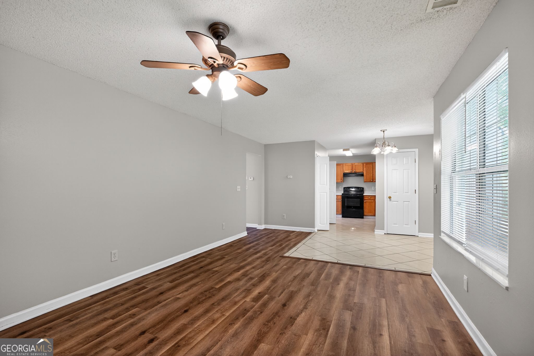 2404 Raven Circle Lithonia, GA 30058 - Photo 11 of 38 wooden floor in an empty room with a window