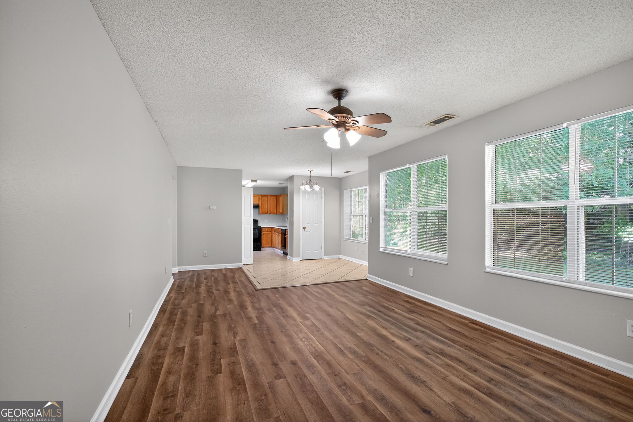 2404 Raven Circle Lithonia, GA 30058 - Photo 12 of 38 a view of an empty room with a window and wooden floor