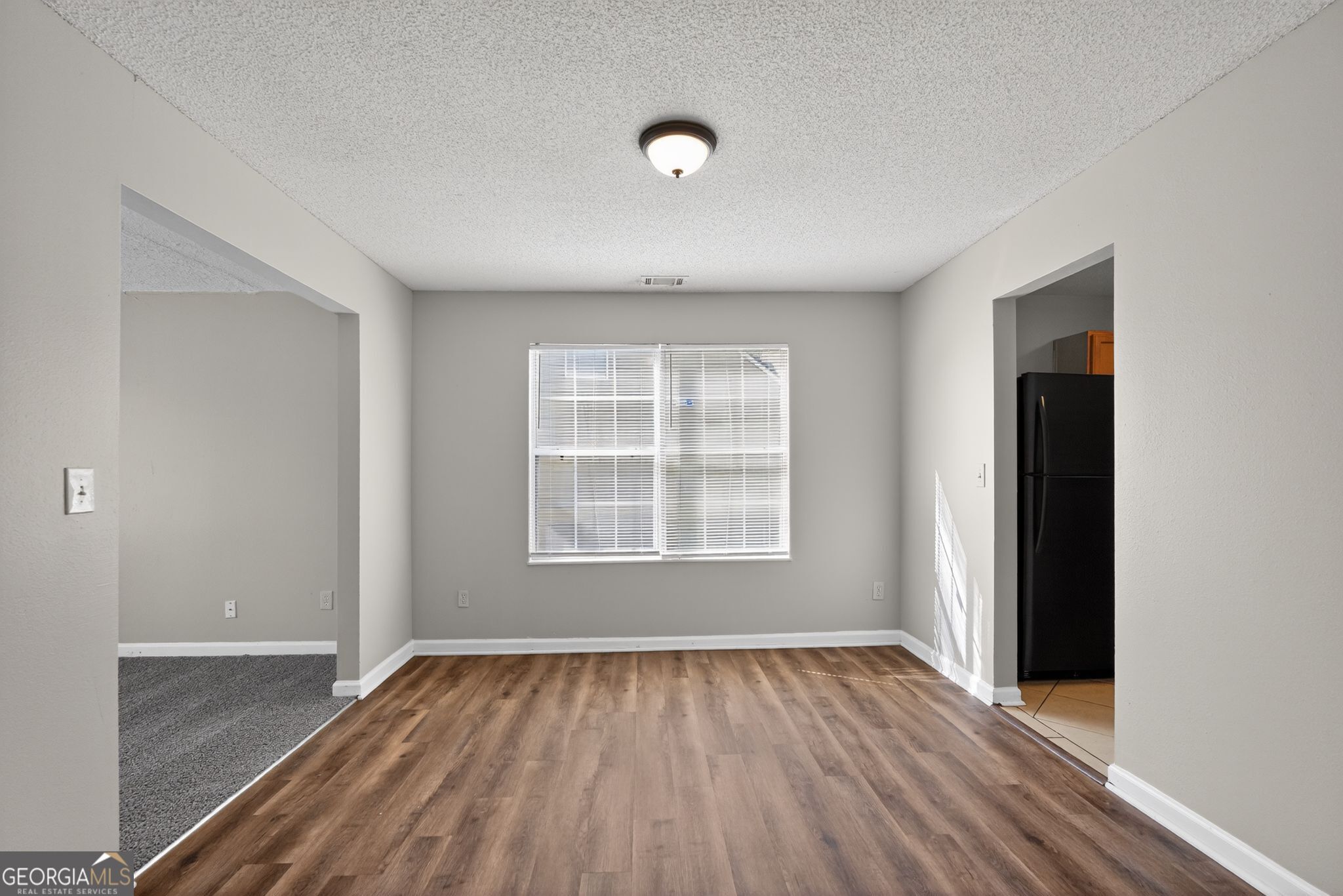 2404 Raven Circle Lithonia, GA 30058 - Photo 14 of 38 an empty room with wooden floor and windows