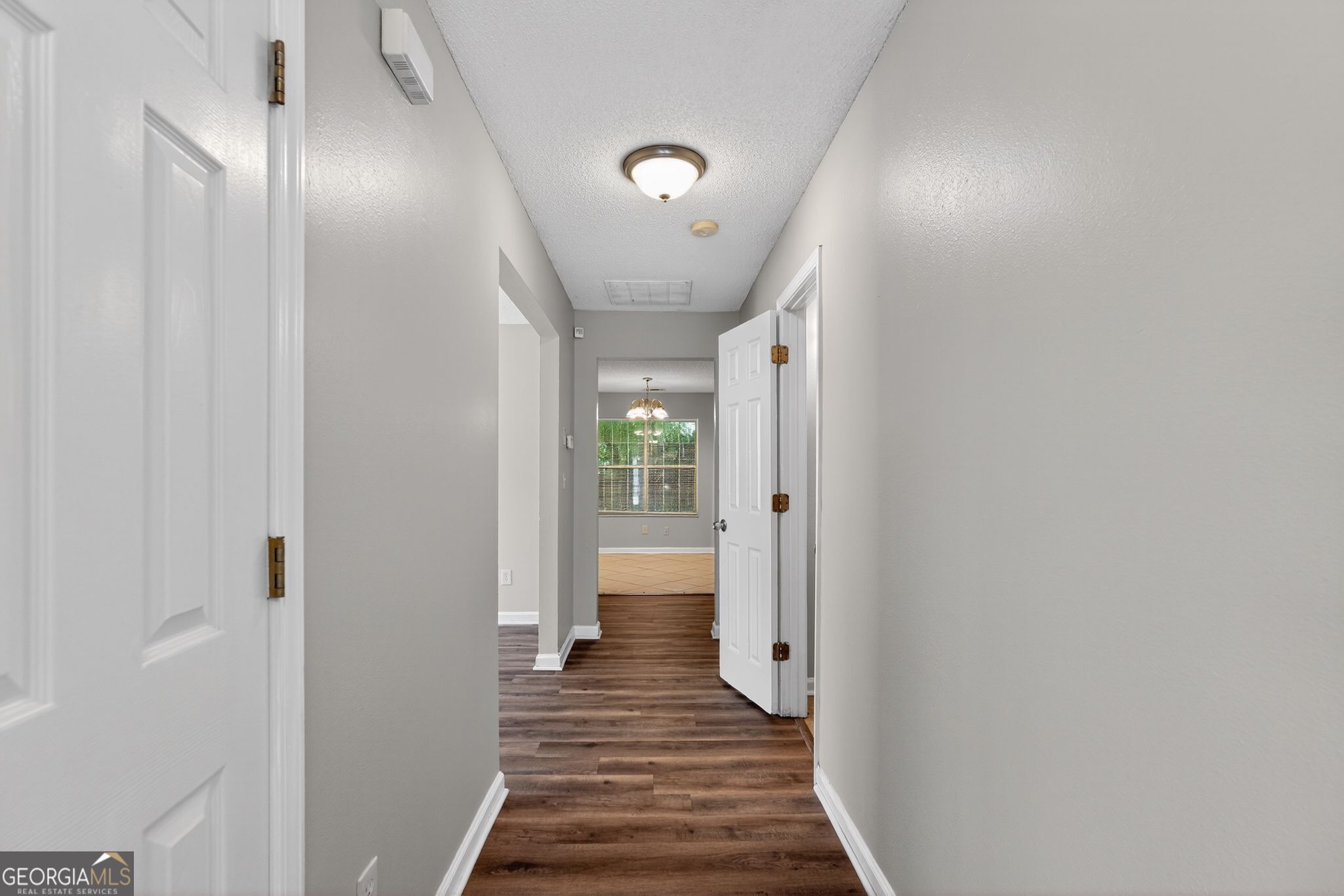 2404 Raven Circle Lithonia, GA 30058 - Photo 18 of 38 a view of a hallway with wooden floor and staircase