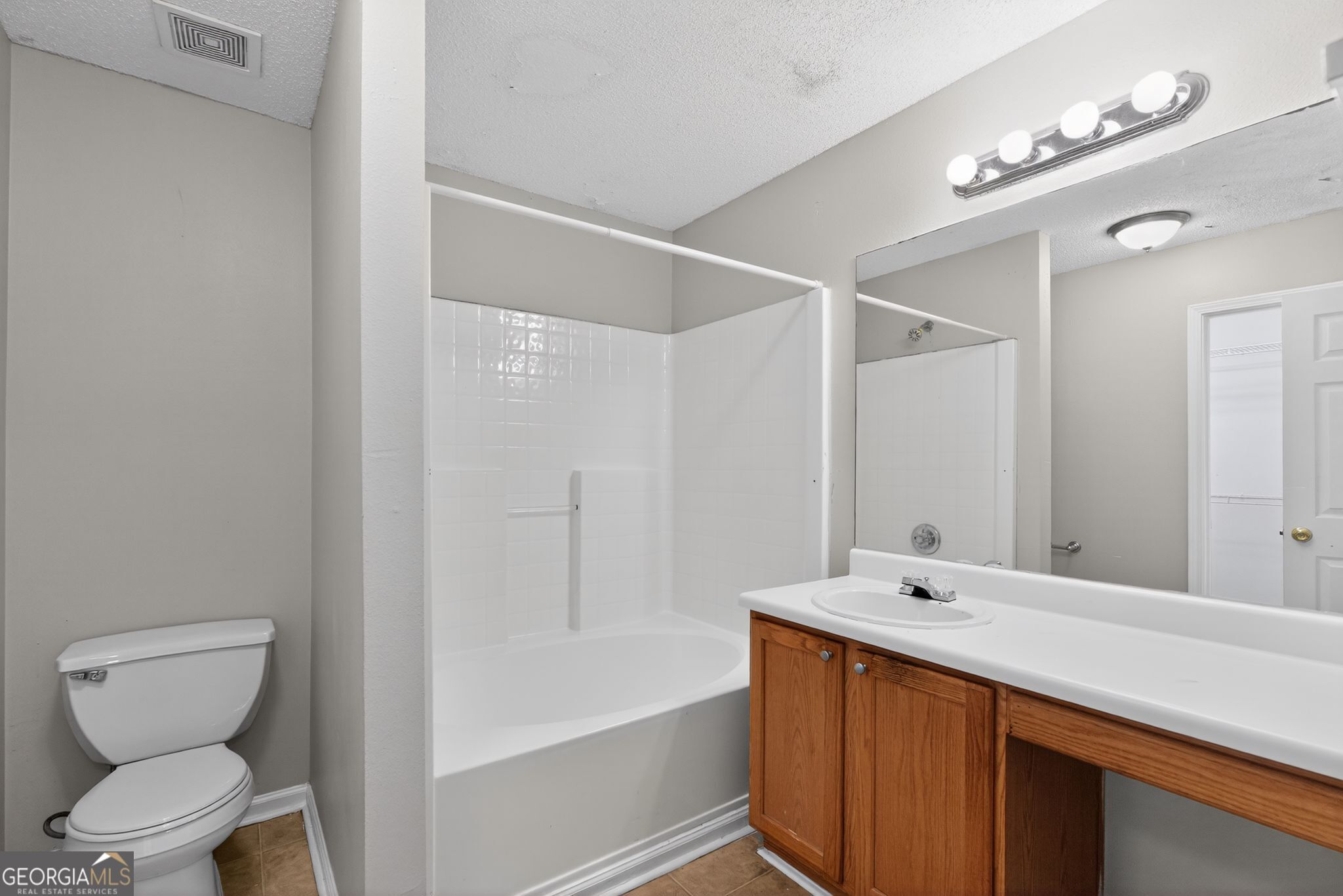 2404 Raven Circle Lithonia, GA 30058 - Photo 26 of 38 a bathroom with a tub sink and a toilet