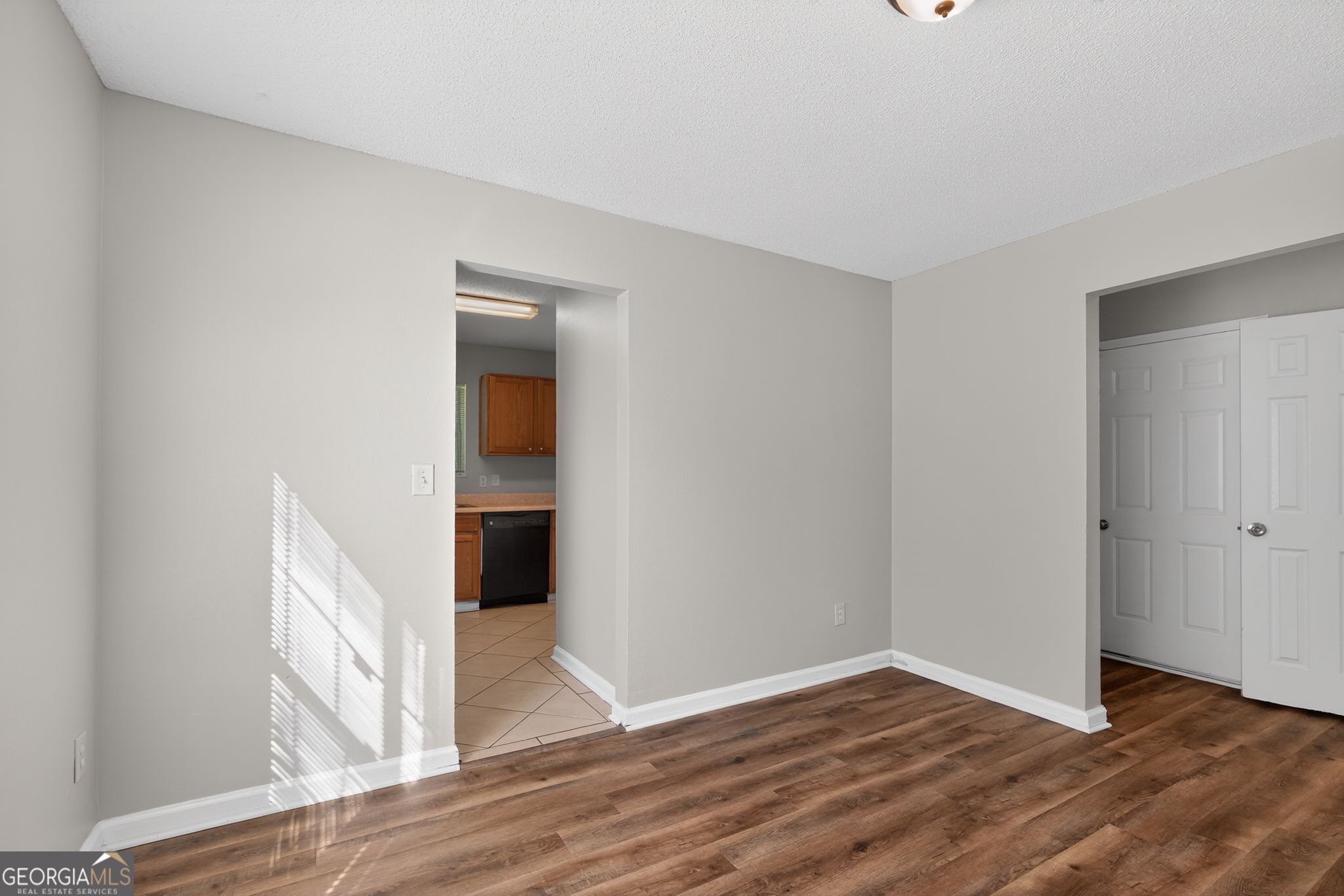 2404 Raven Circle Lithonia, GA 30058 - Photo 35 of 38 a view of an empty room with wooden floor and closet