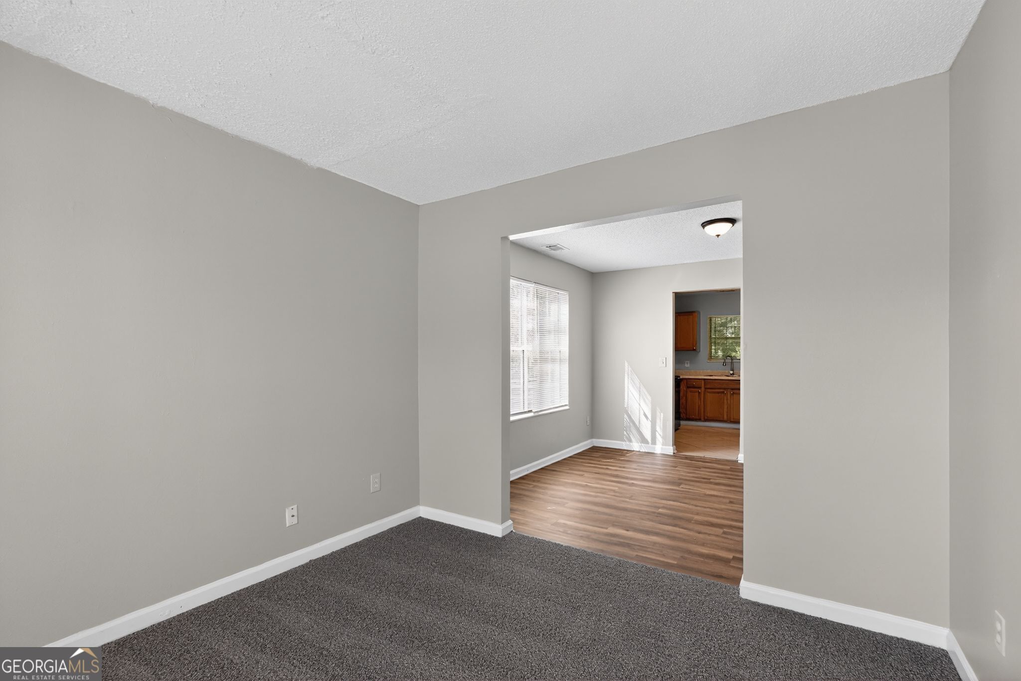2404 Raven Circle Lithonia, GA 30058 - Photo 6 of 38 a view of an empty room with window and wooden floor