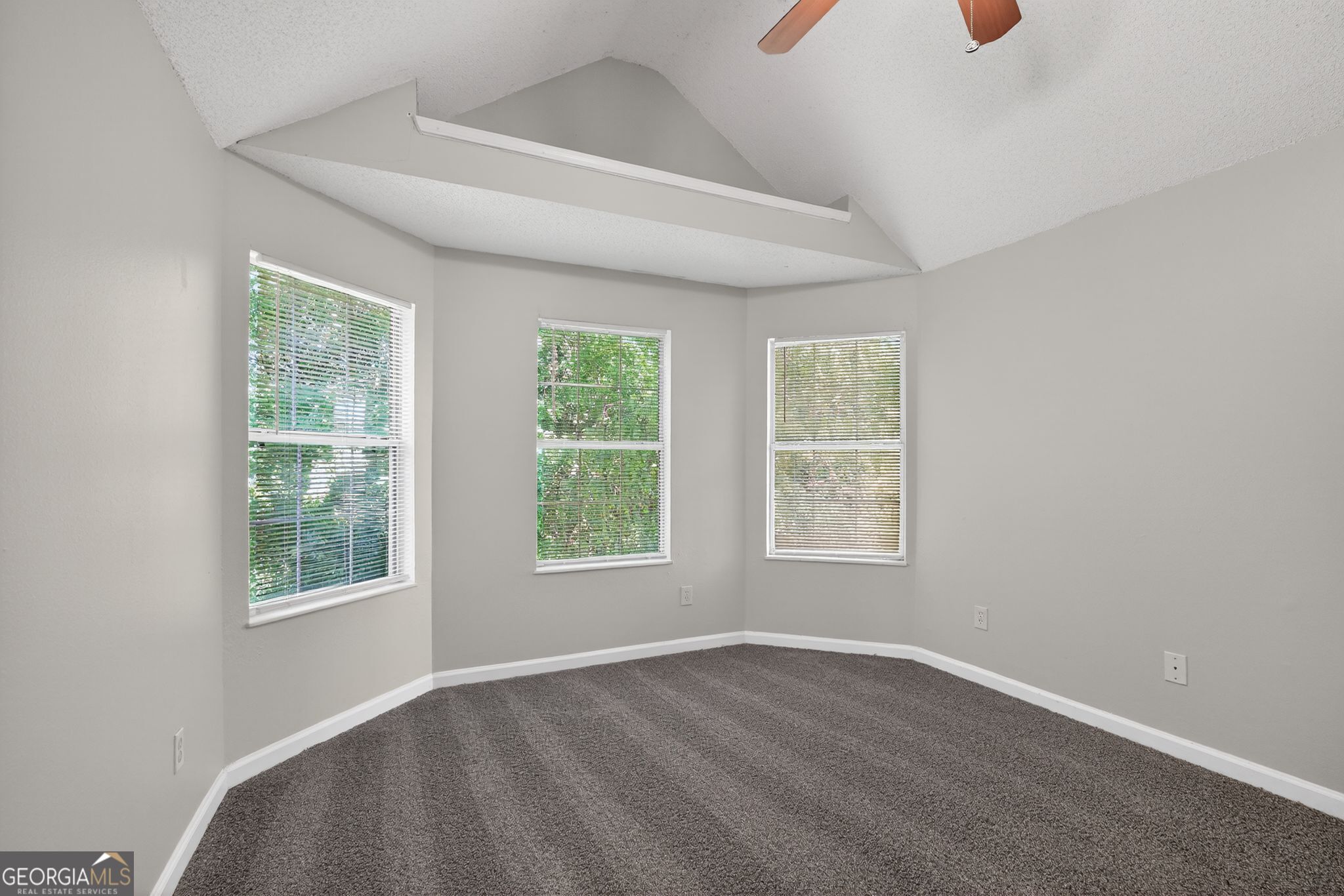 2404 Raven Circle Lithonia, GA 30058 - Photo 8 of 38 an empty room with wooden floor and windows