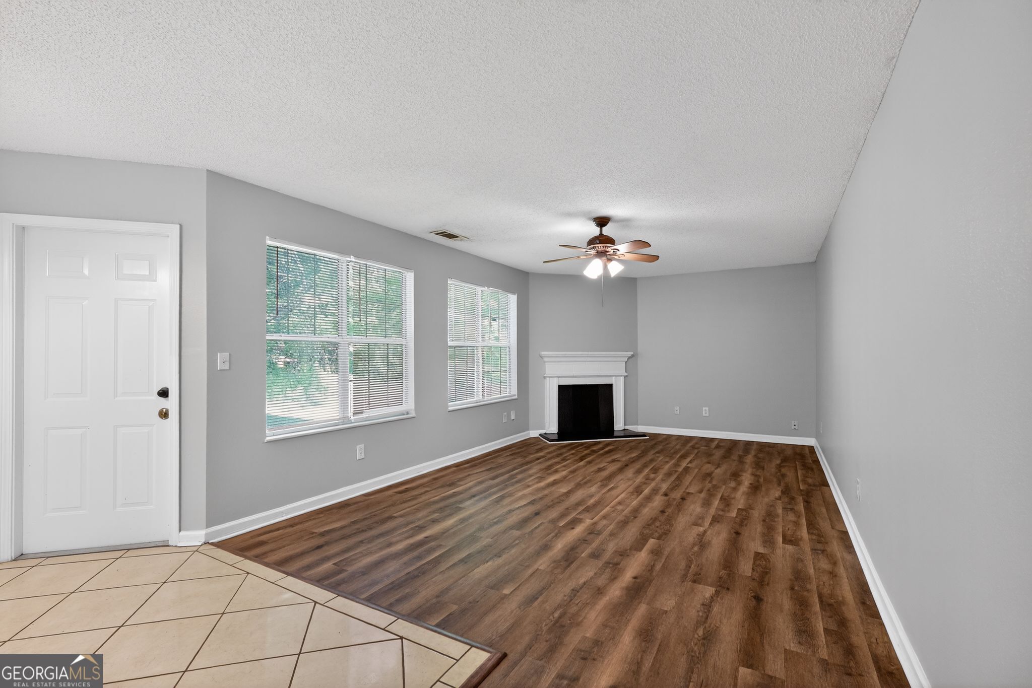 2404 Raven Circle Lithonia, GA 30058 - Photo 9 of 38 a view of an empty room with window and chandelier fan
