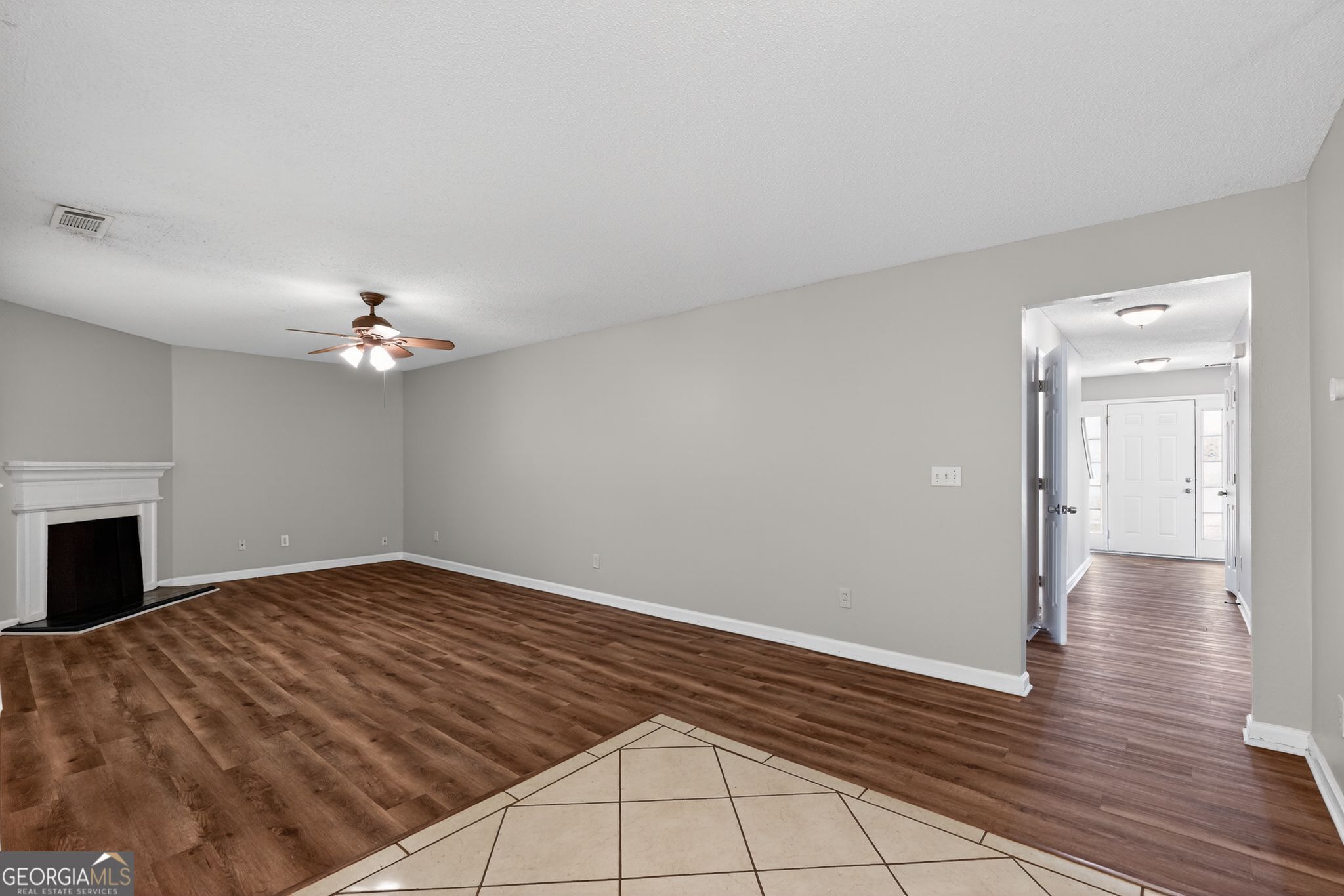 2404 Raven Circle Lithonia, GA 30058 - Photo 10 of 38 a view of empty room with wooden floor and ceiling fan