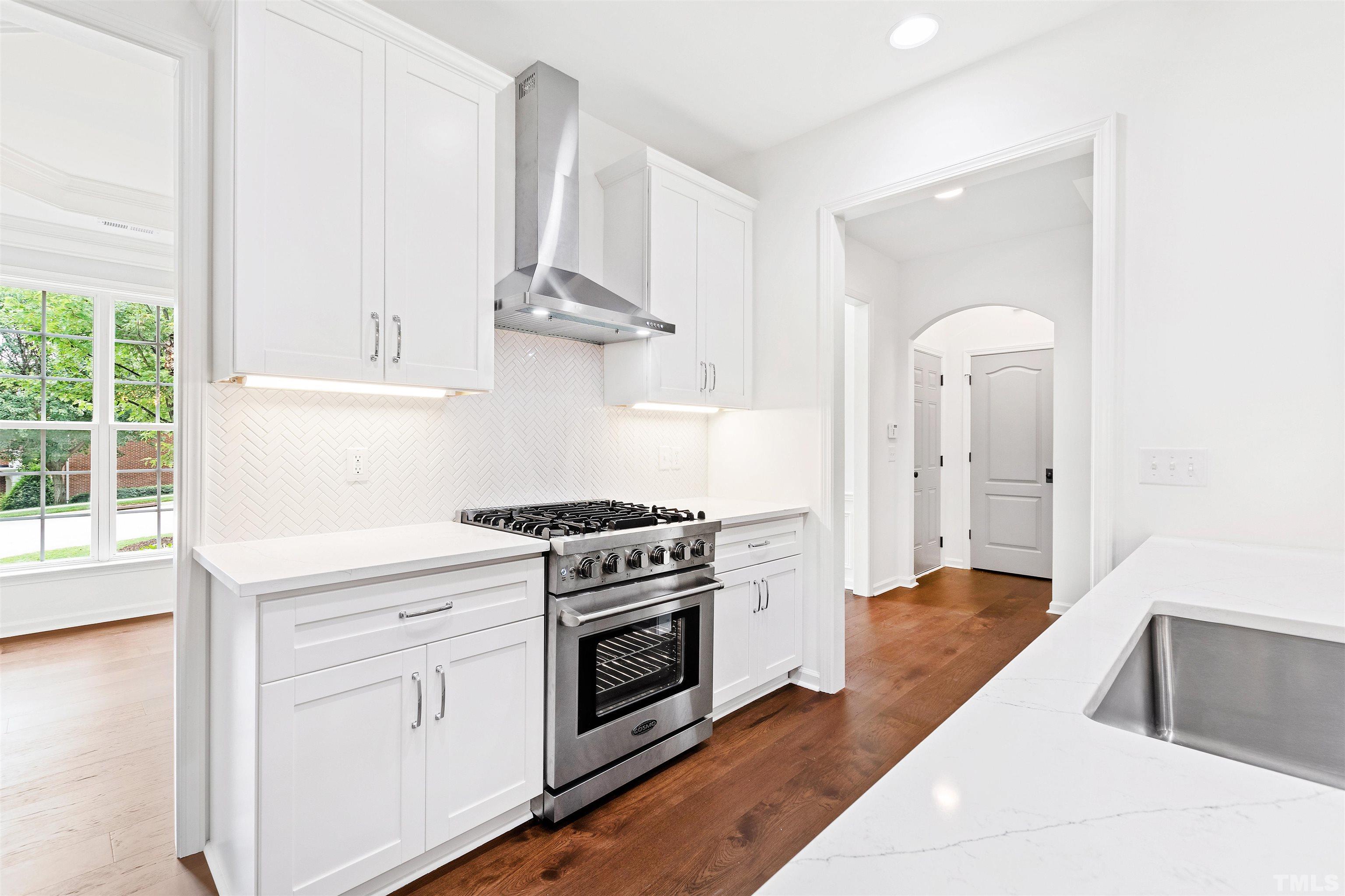 4618 Manassa Pope Lane Raleigh, NC 27612 - Photo 13 of 45 a kitchen with white cabinets and appliances