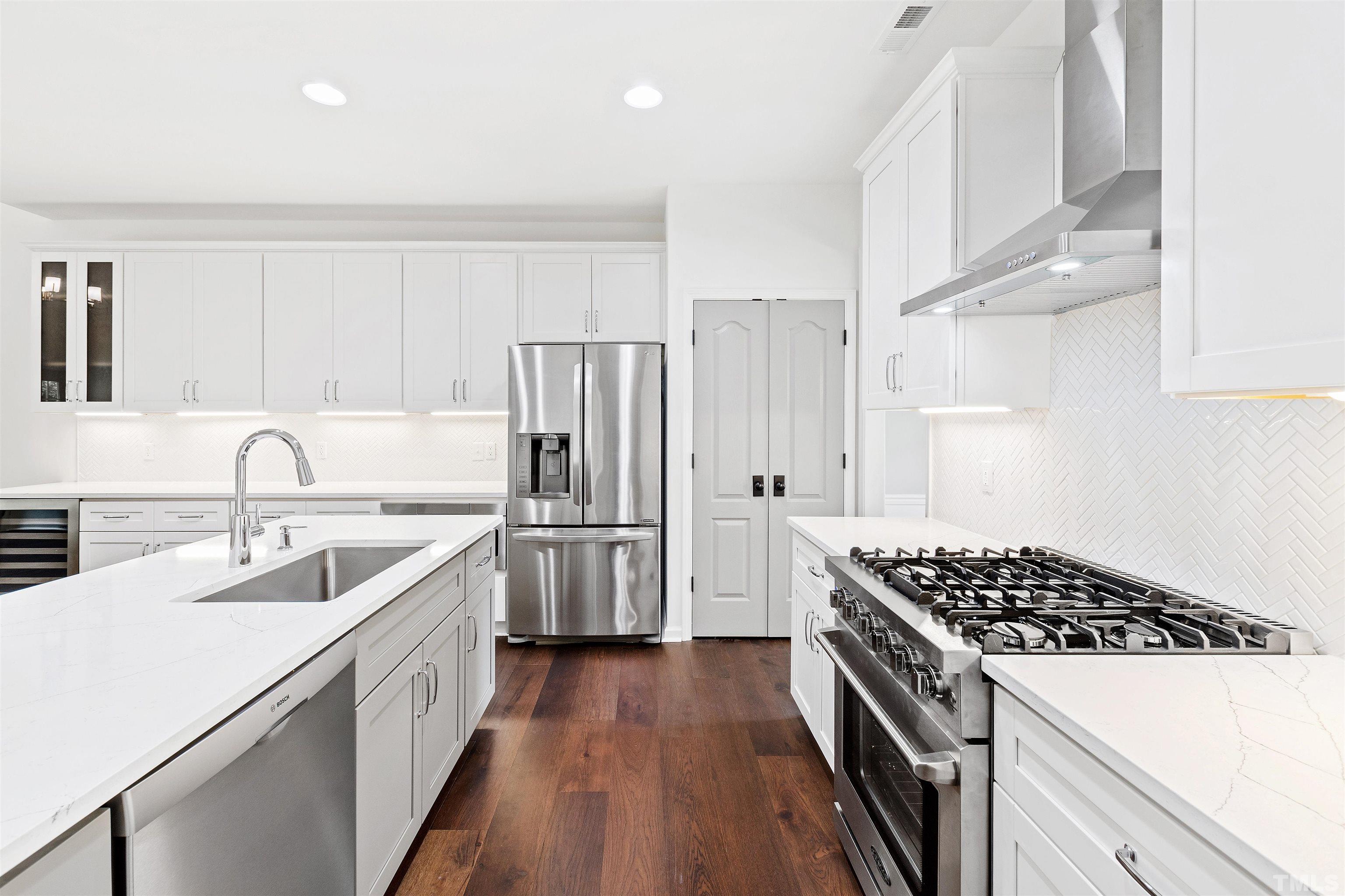 4618 Manassa Pope Lane Raleigh, NC 27612 - Photo 15 of 45 a kitchen with a sink a stove and refrigerator