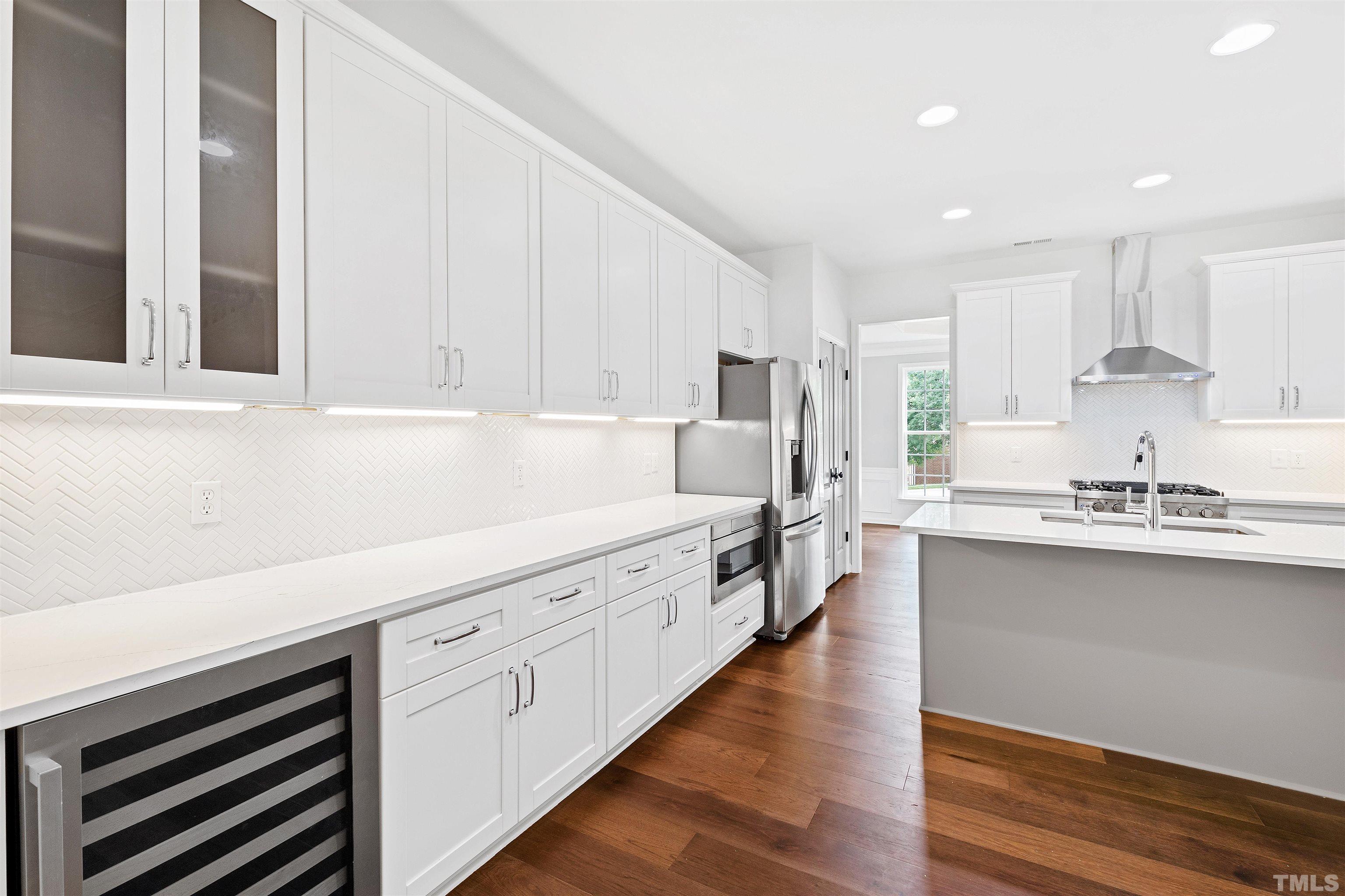 4618 Manassa Pope Lane Raleigh, NC 27612 - Photo 17 of 45 a kitchen with granite countertop white cabinets and white appliances