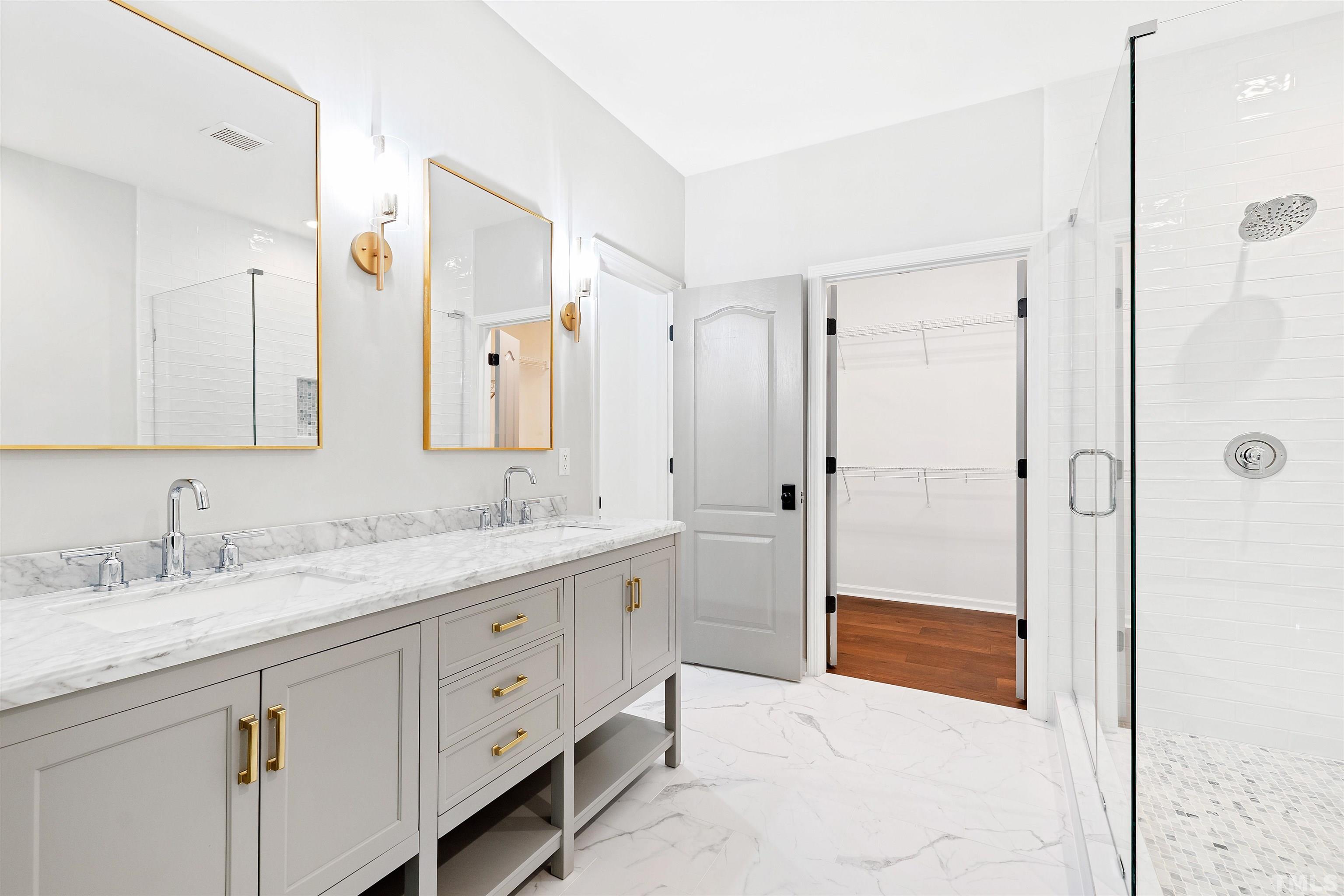 4618 Manassa Pope Lane Raleigh, NC 27612 - Photo 23 of 45 a spacious bathroom with a shower sink and mirror