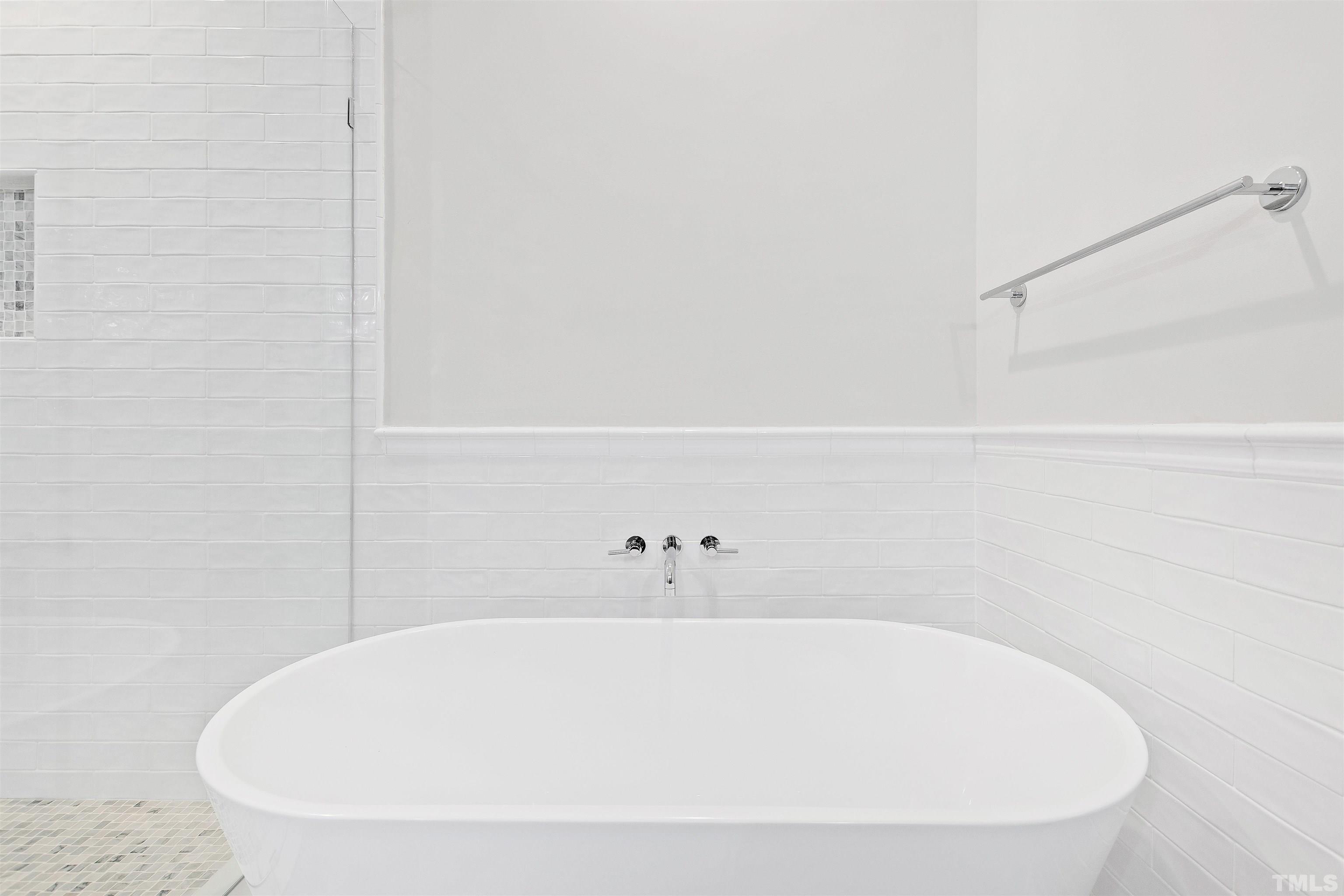 4618 Manassa Pope Lane Raleigh, NC 27612 - Photo 24 of 45 a white bath tub sitting in a bathroom