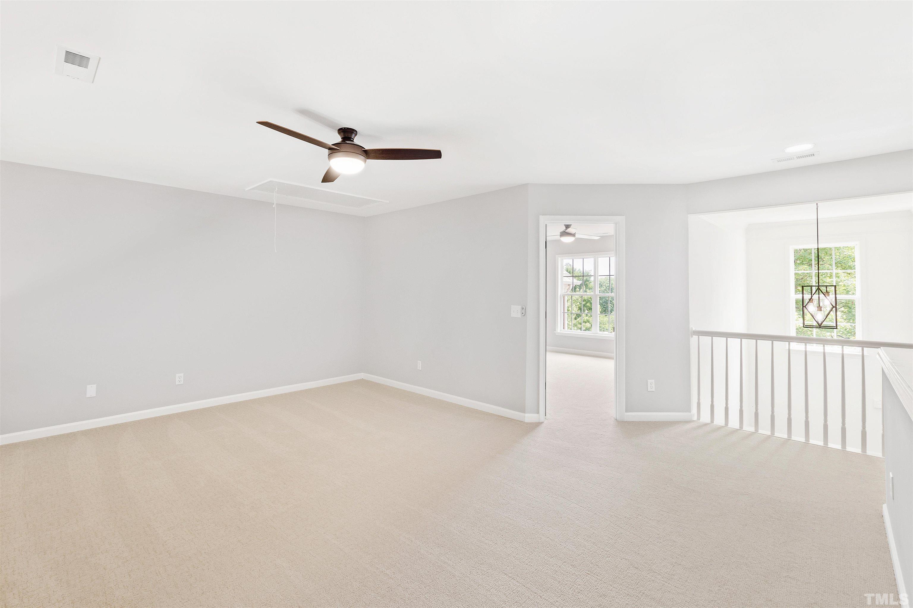 4618 Manassa Pope Lane Raleigh, NC 27612 - Photo 27 of 45 an empty room with windows and ceiling fan