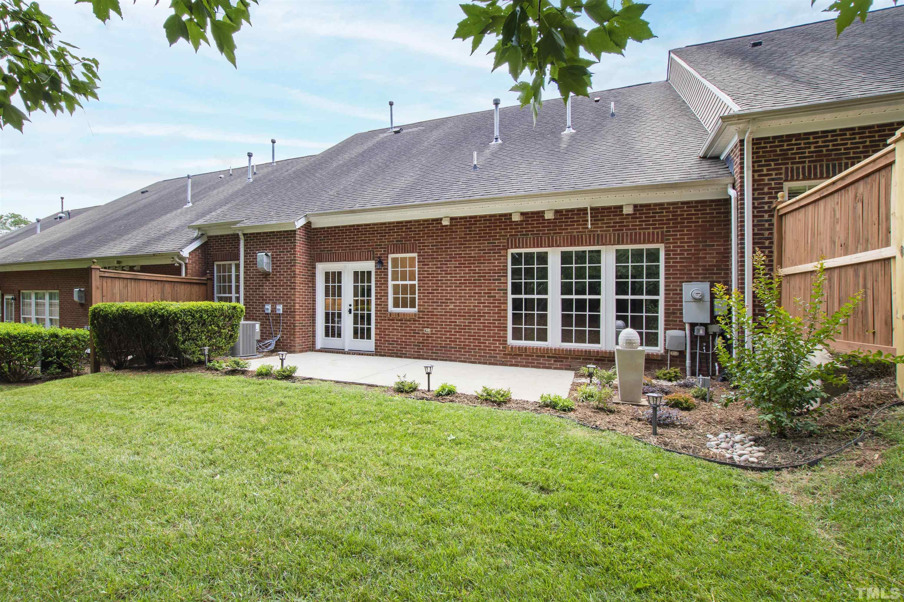 4618 Manassa Pope Lane Raleigh, NC 27612 - Photo 42 of 45 a front view of a house with a yard and outdoor seating