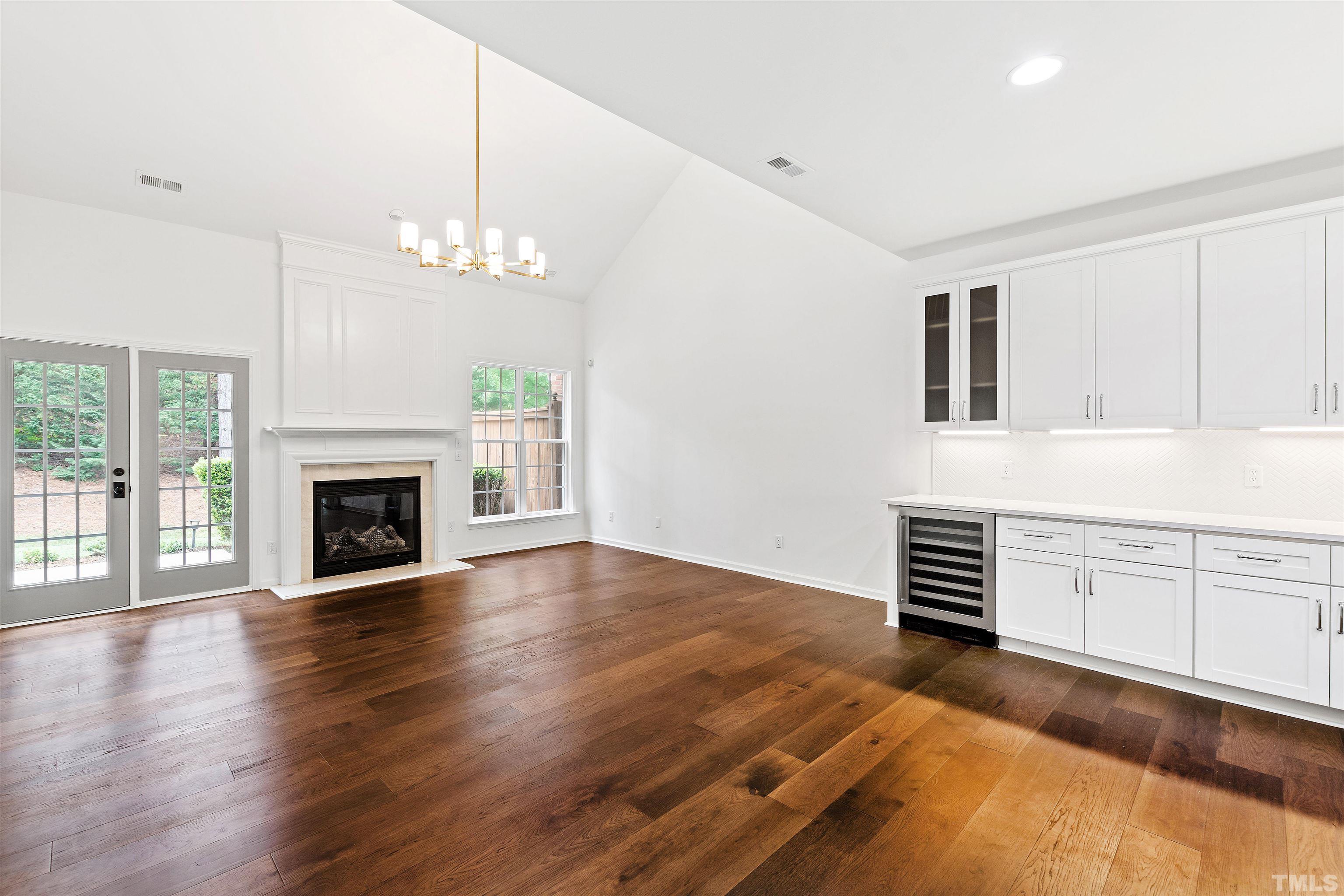 4618 Manassa Pope Lane Raleigh, NC 27612 - Photo 9 of 45 a view of an empty room with window and wooden floor