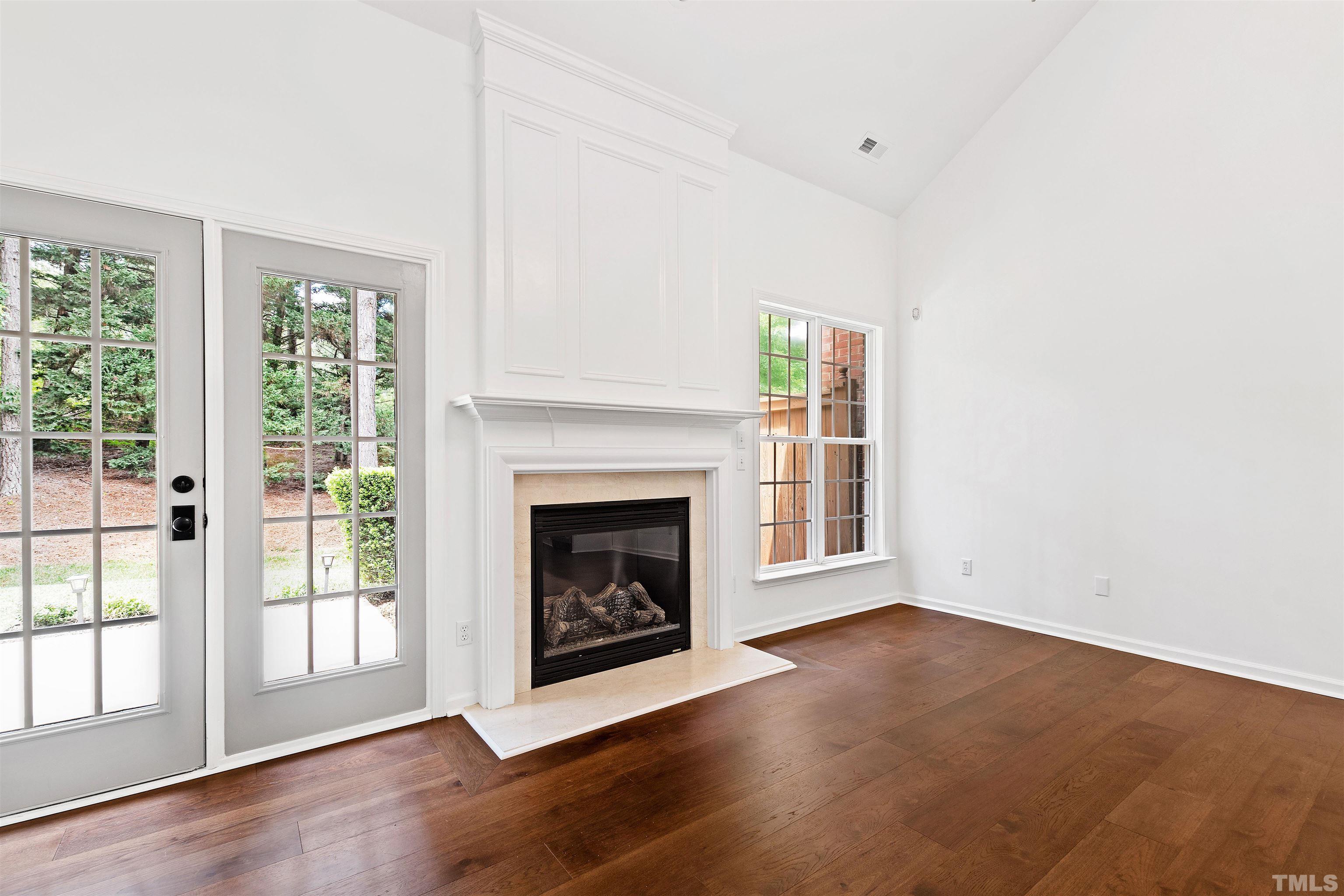 4618 Manassa Pope Lane Raleigh, NC 27612 - Photo 10 of 45 a view of an empty room with wooden floor and a window