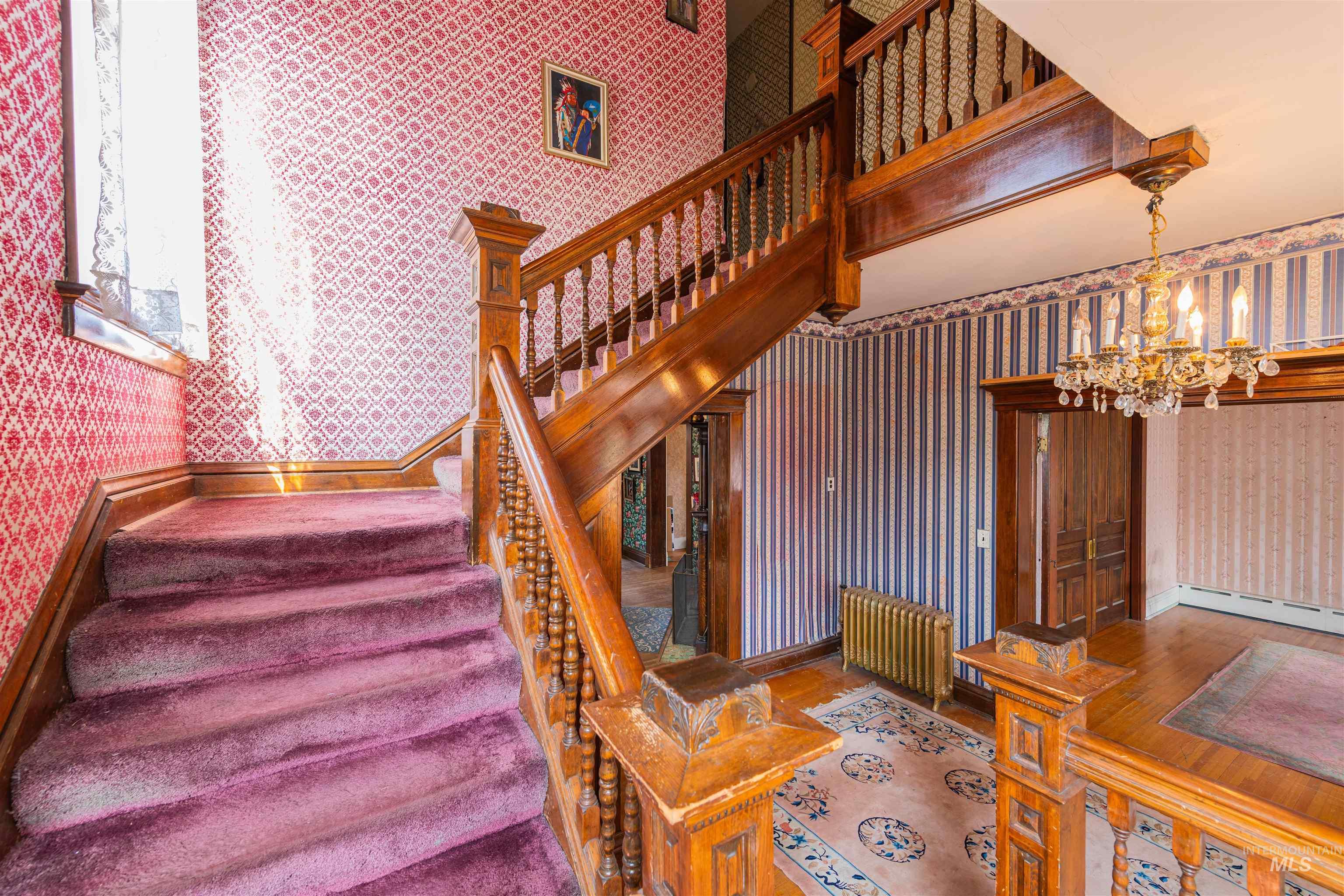 507 7th Avenue Lewiston, ID 83501 - Photo 19 of 30 Stairway with wallpapered walls, radiator, and a chandelier