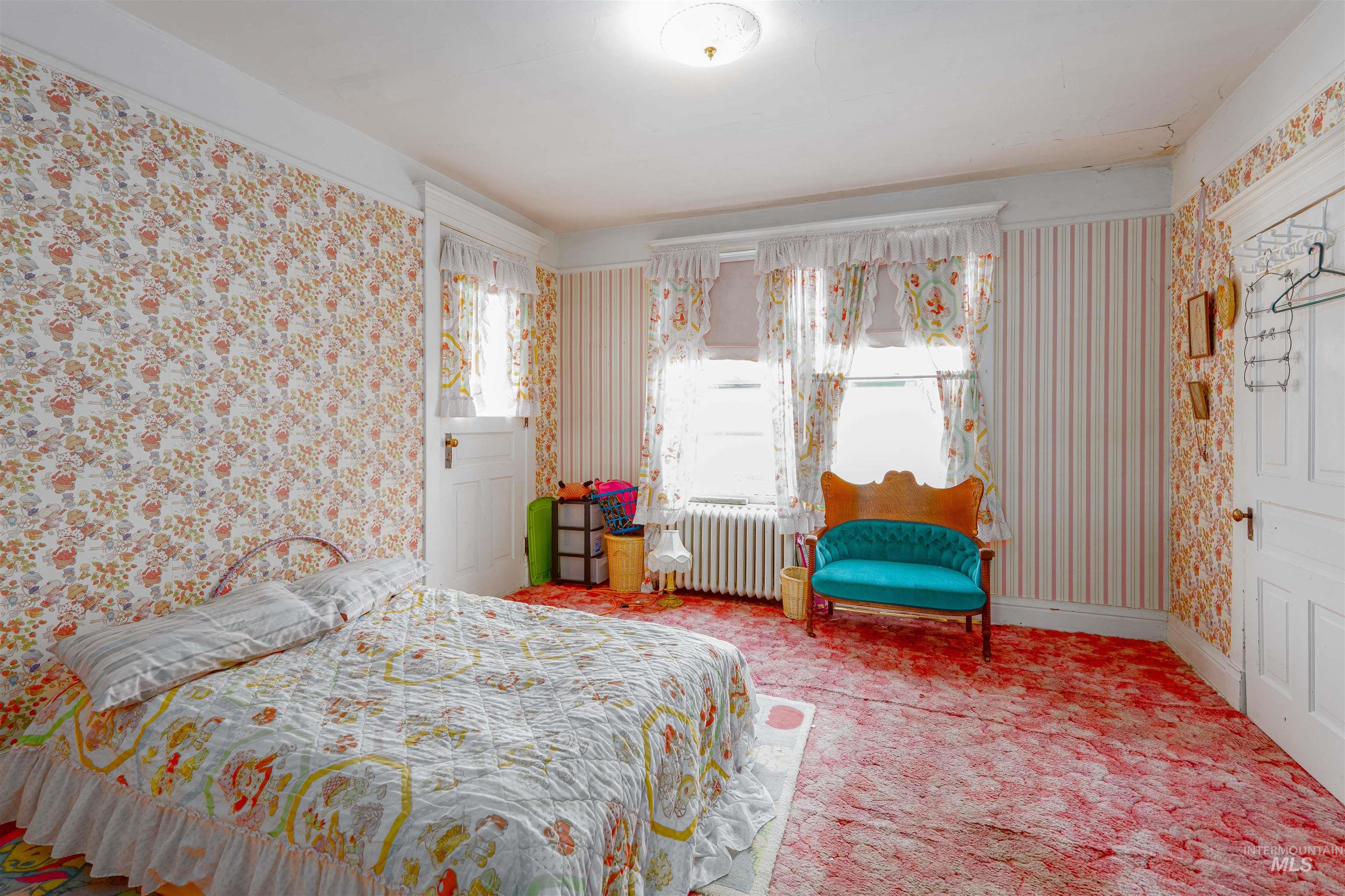 507 7th Avenue Lewiston, ID 83501 - Photo 21 of 30 Carpeted bedroom with wallpapered walls and radiator heating unit