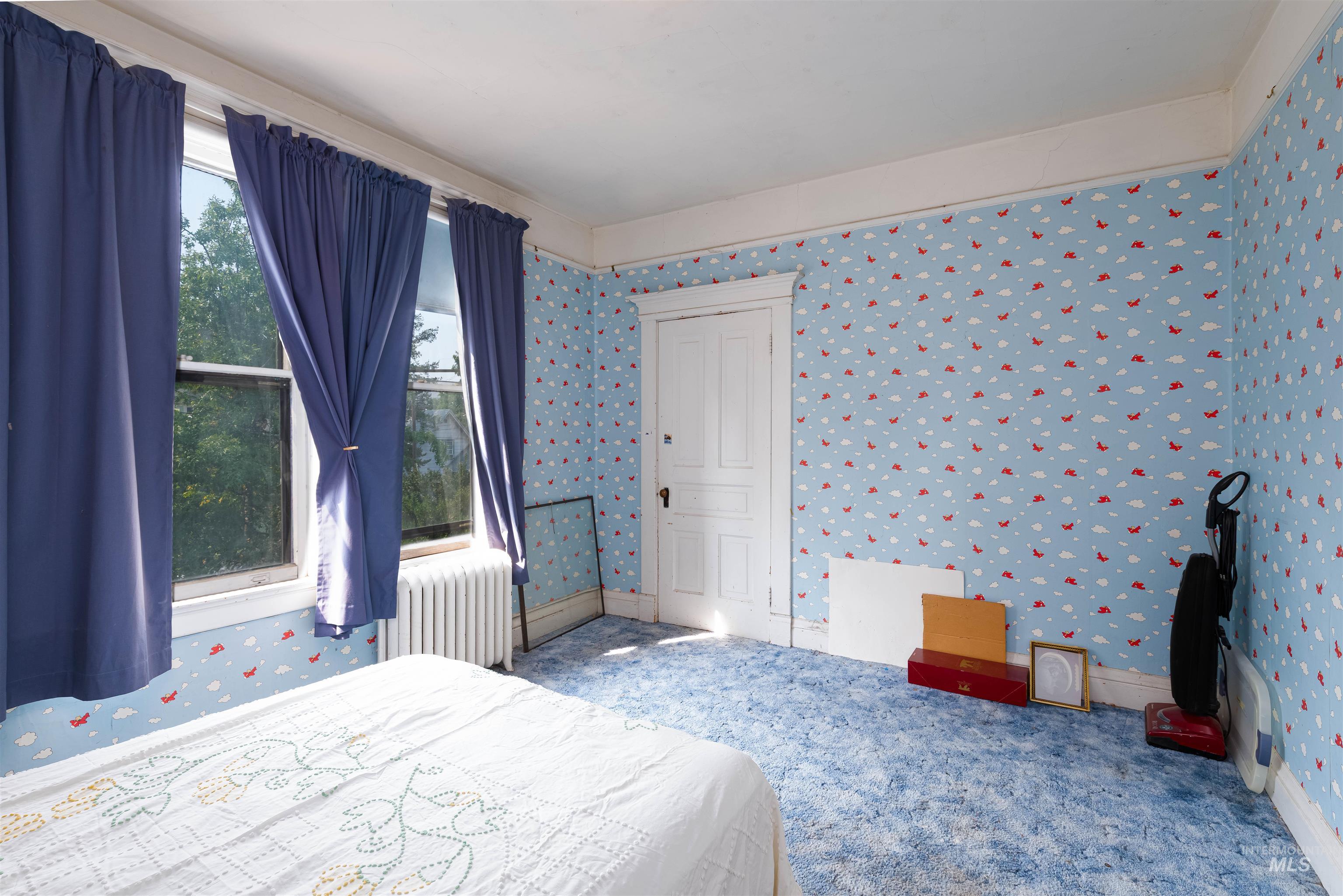 507 7th Avenue Lewiston, ID 83501 - Photo 25 of 30 Bedroom with wallpapered walls, radiator heating unit, and carpet flooring