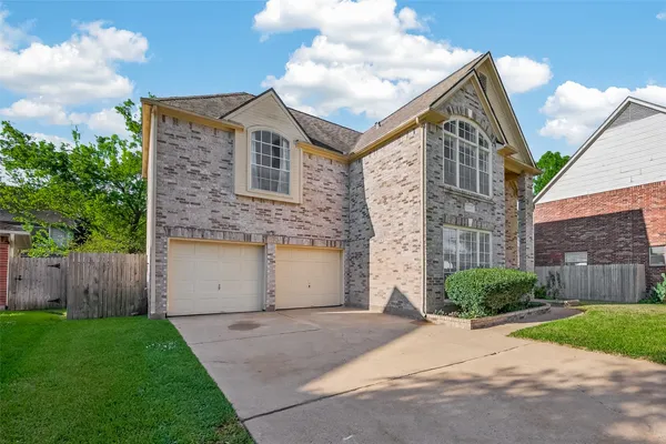 a view of a brick house with a yard