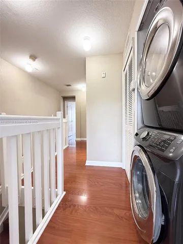 a view of a hallway with washer and dryer