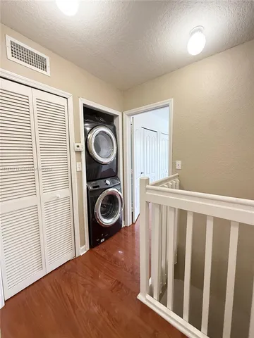 a view of a bedroom with washer and dryer