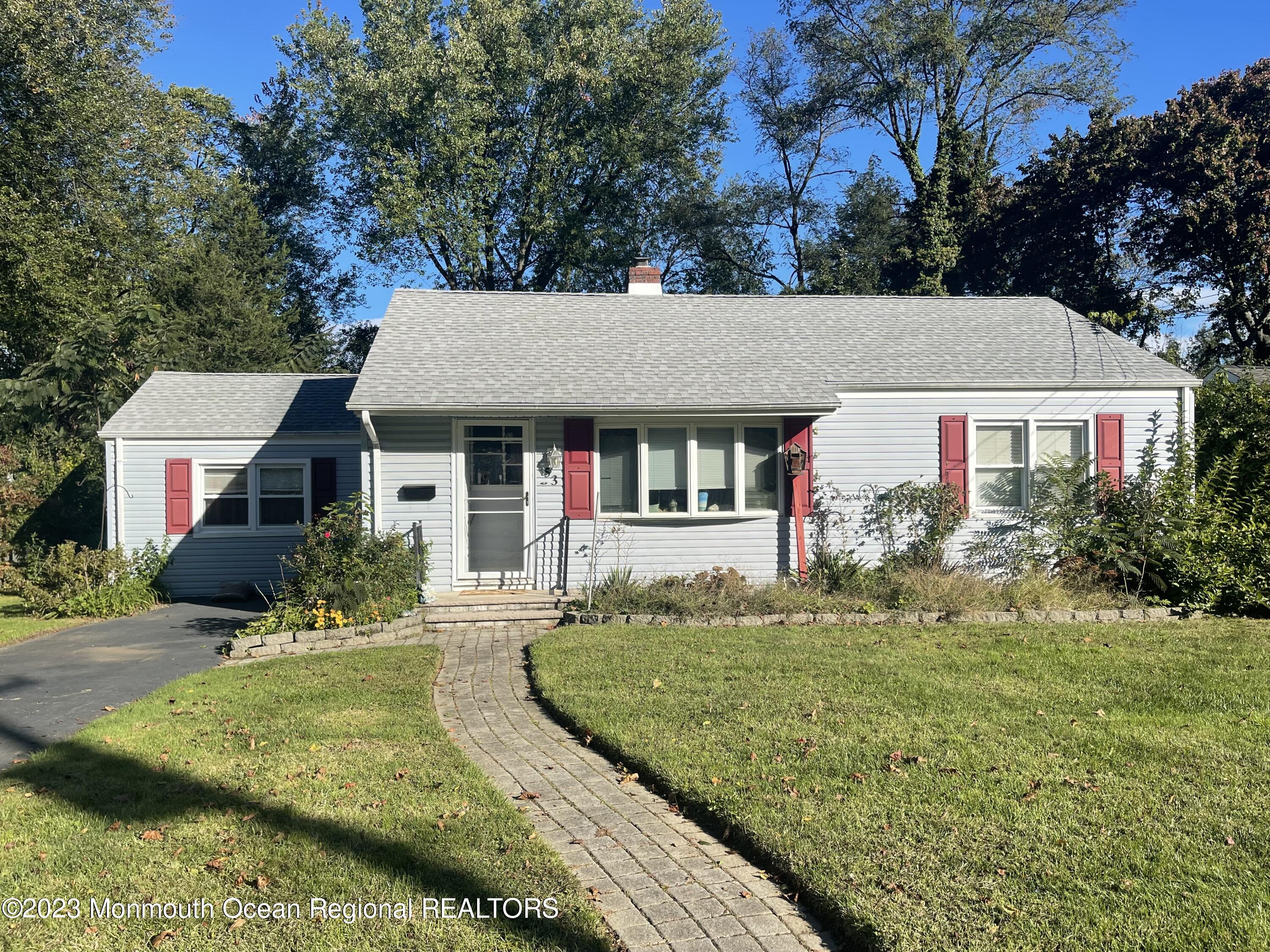 a front view of a house with a yard table and chairs