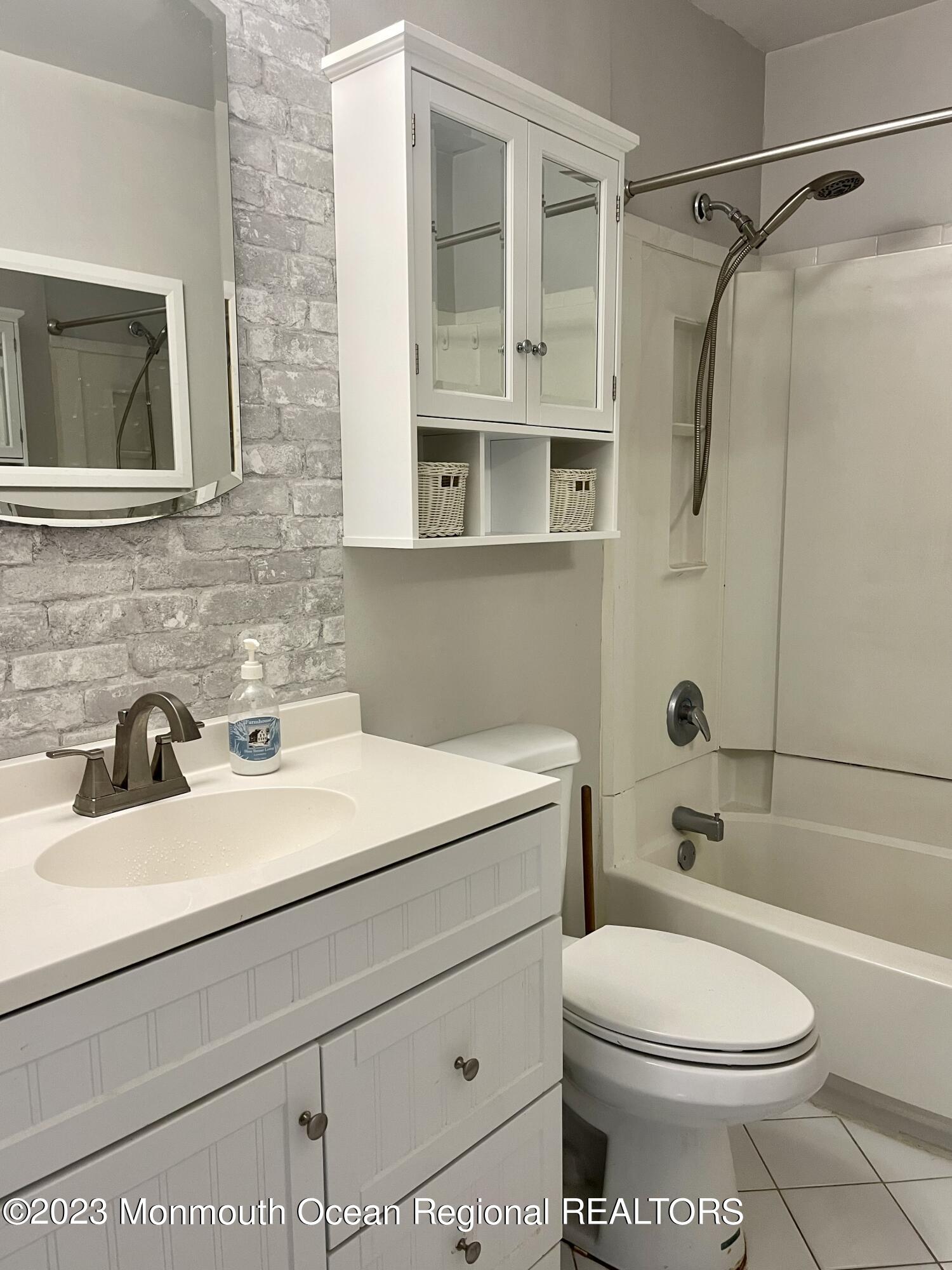 53 Crestview Drive Middletown, NJ 07748 - Photo 14 of 21 a bathroom with a sink a toilet and shower