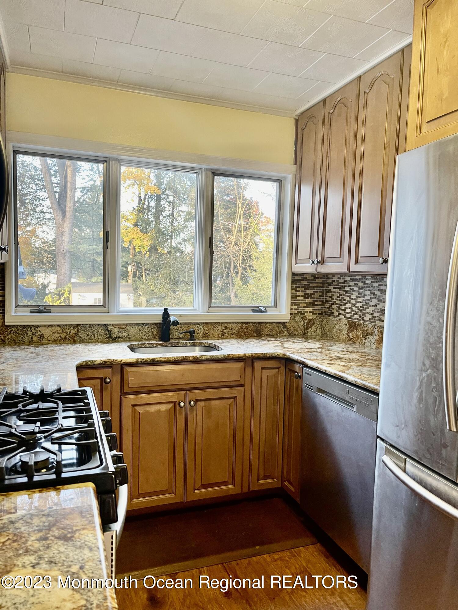 53 Crestview Drive Middletown, NJ 07748 - Photo 6 of 21 a large kitchen with stainless steel appliances granite countertop a stove a sink and a refrigerator