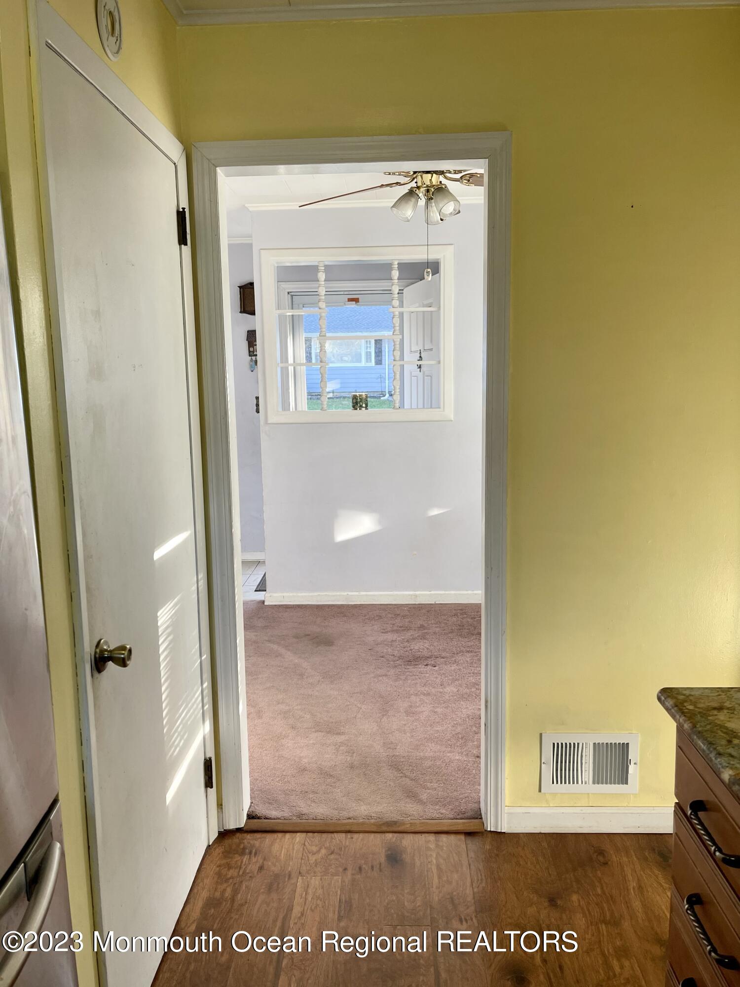 53 Crestview Drive Middletown, NJ 07748 - Photo 7 of 21 a view of a hallway with wooden floor and a living room
