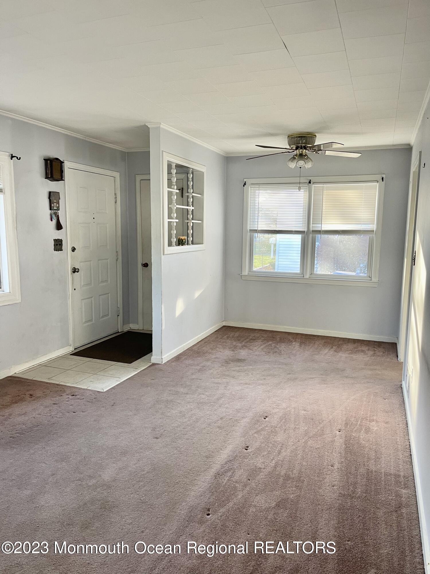 53 Crestview Drive Middletown, NJ 07748 - Photo 10 of 21 an empty room with windows and chandelier