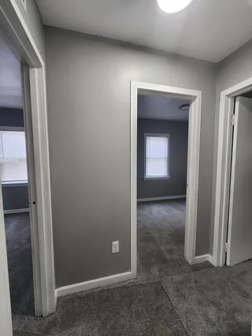 an empty room with closet and mirror