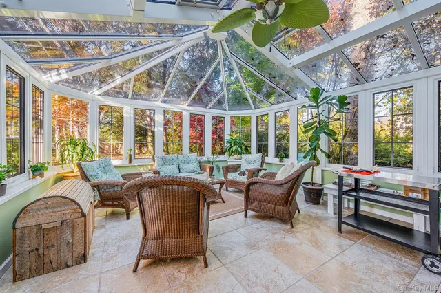 a living room with furniture a large window and chandelier