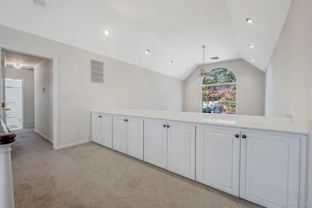 an entryway with chandelier and window