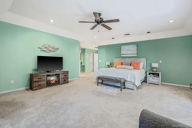a bedroom with furniture and a flat screen tv
