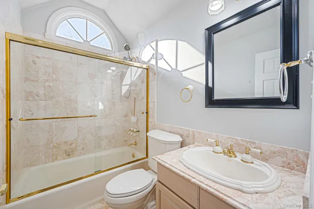 a bathroom with a sink a mirror a bathtub and a shower