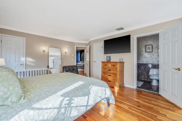 a bedroom with a bed and a television