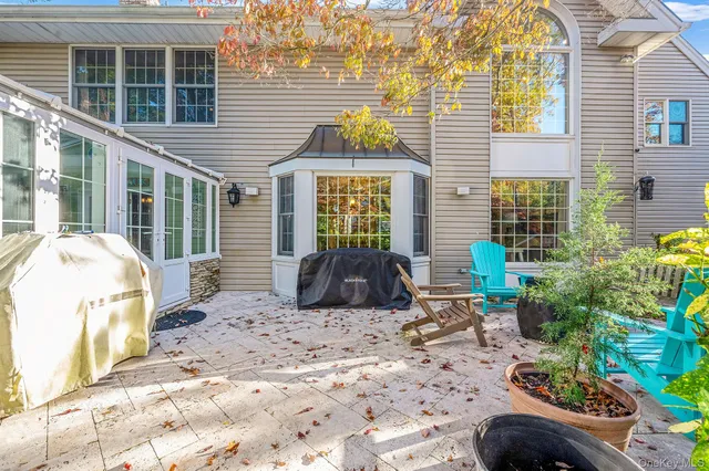 a view of a house with backyard sitting area and garden