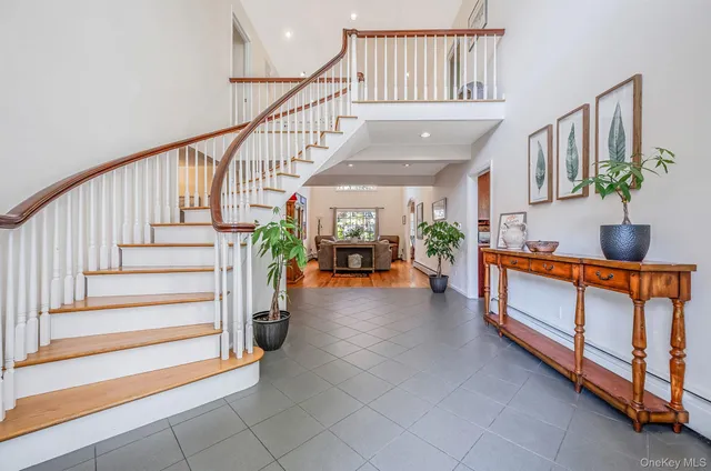 a view of entryway bedroom and hall with wooden floor