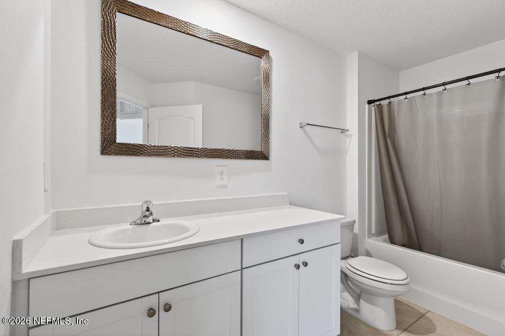 45 Seaport Breeze Road St. Augustine, FL 32095 - Photo 57 of 88 a bathroom with a sink a toilet and a mirror
