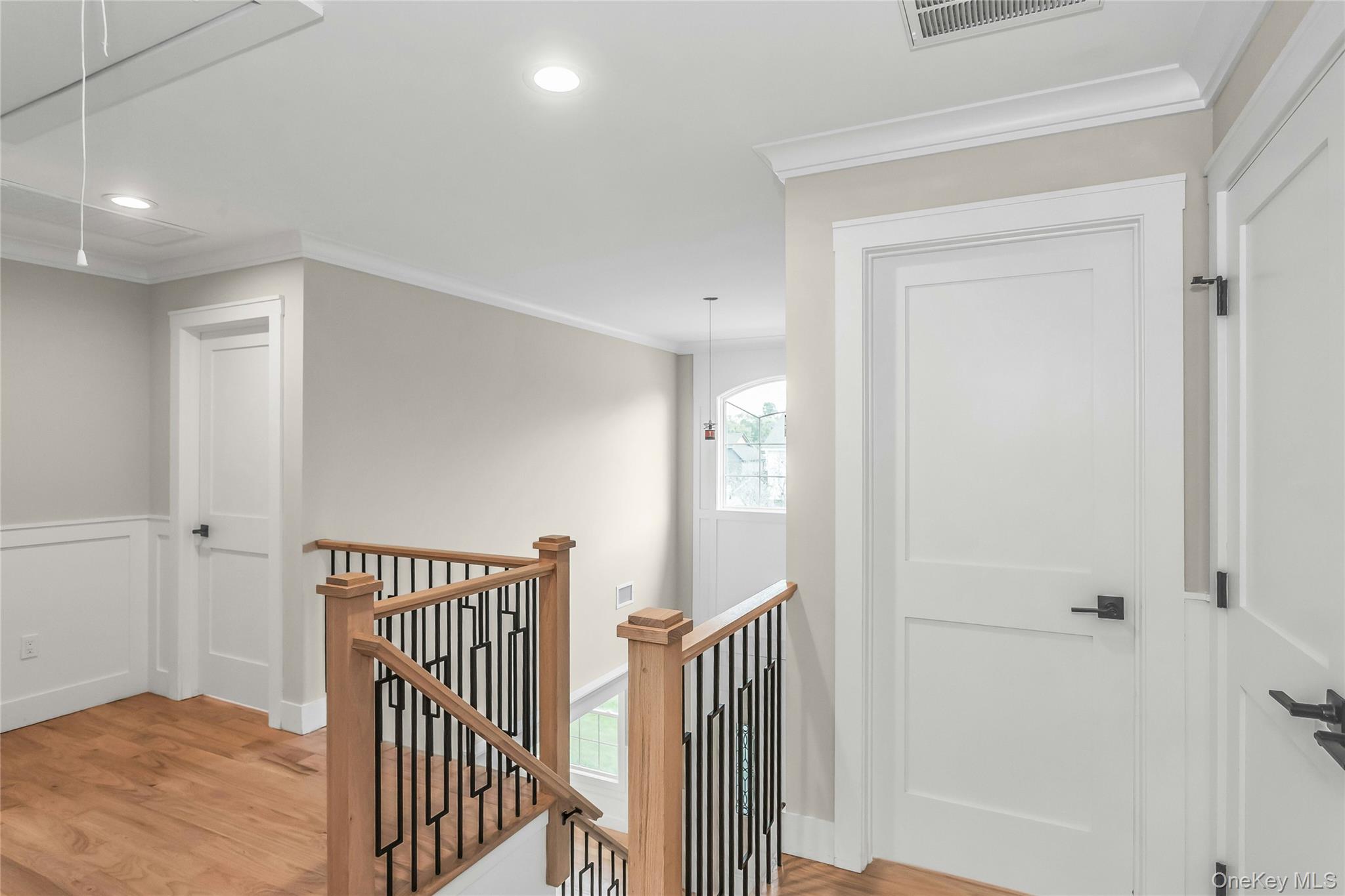 8 Sebree Place Plainview, NY 11803 - Photo 15 of 26 Corridor featuring light wood-type flooring, an upstairs landing, ornamental molding, recessed lighting, and attic access