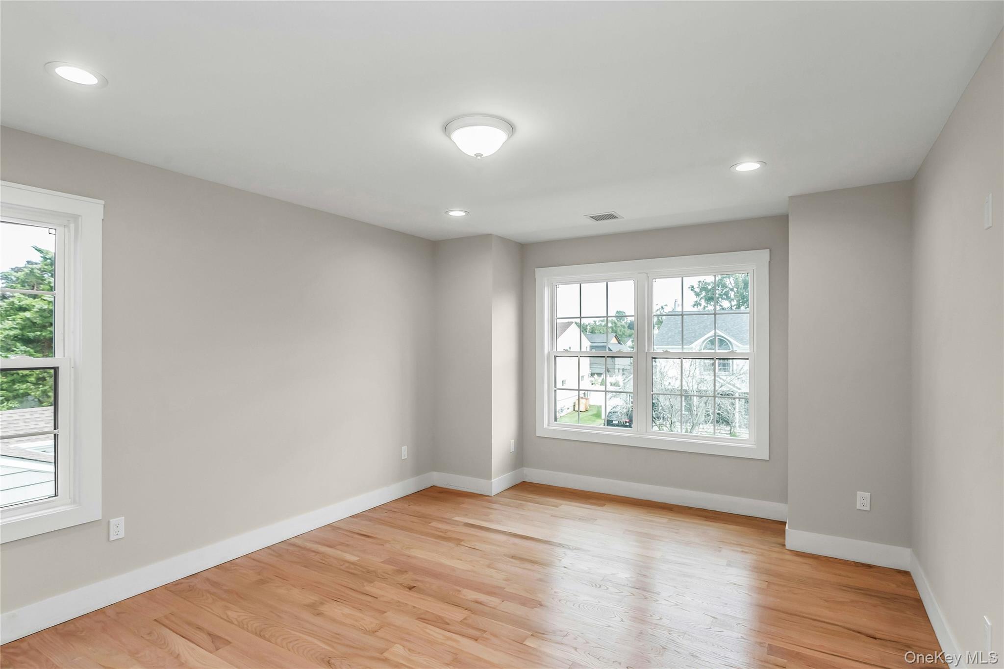 8 Sebree Place Plainview, NY 11803 - Photo 21 of 26 Unfurnished room featuring recessed lighting and light wood-type flooring