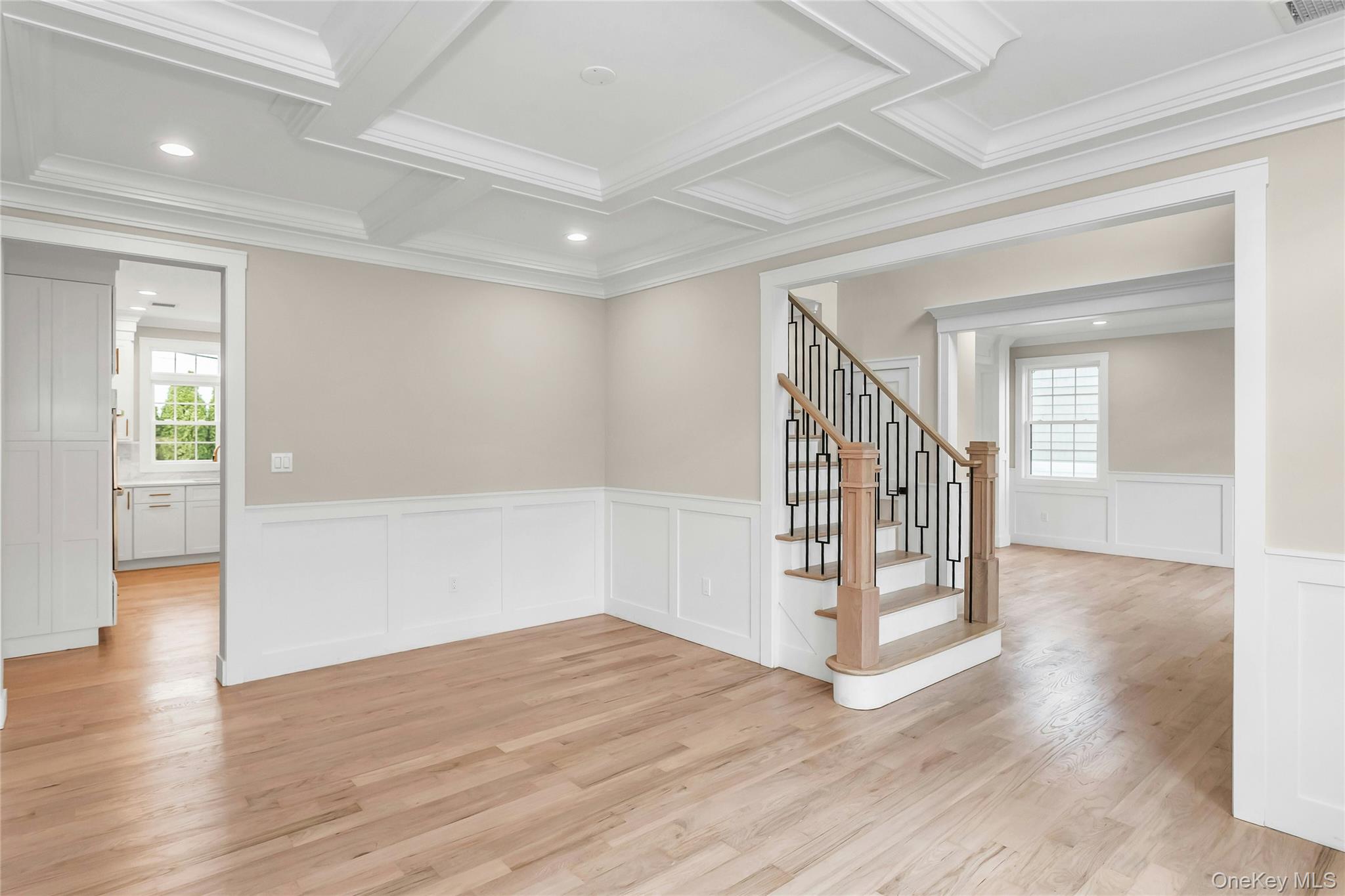 8 Sebree Place Plainview, NY 11803 - Photo 4 of 26 Empty room with light wood-style floors, stairs, recessed lighting, coffered ceiling, and ornamental molding