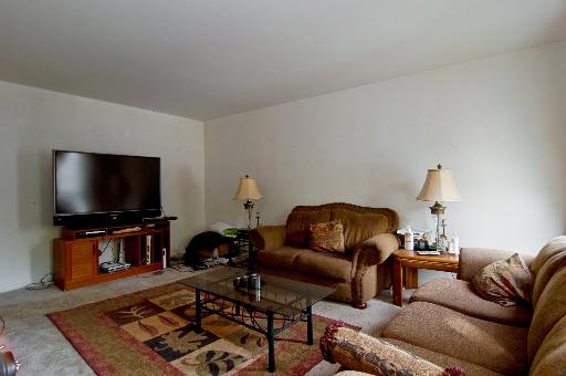 2084 Sutherland Place Hoffman Estates, IL 60169 - Photo 4 of 9 a living room with furniture and a flat screen tv