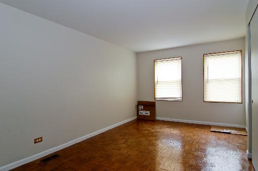2084 Sutherland Place Hoffman Estates, IL 60169 - Photo 7 of 9 an empty room with wooden floor and windows